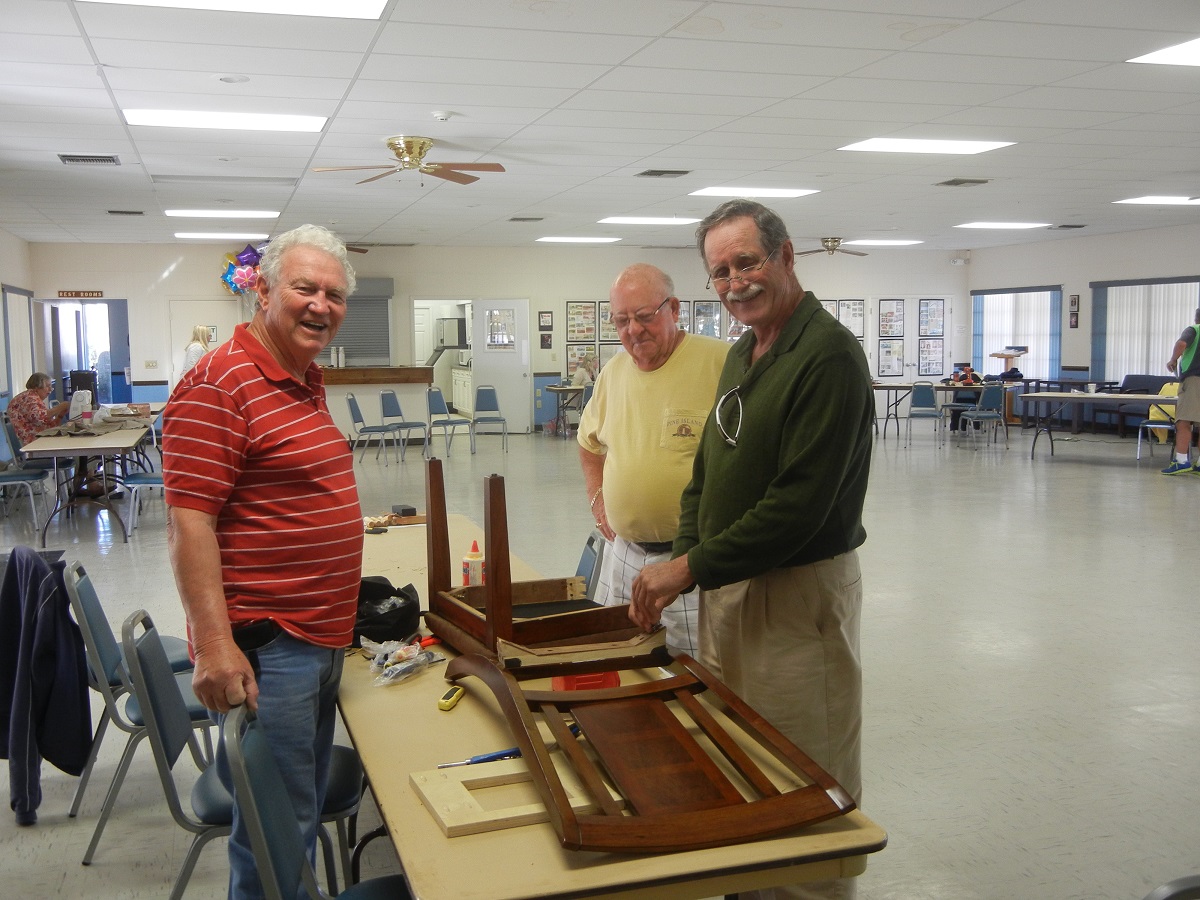 7. Jim Dunlop, Bob Petican and Dick Lemay repair wobbly legs on a chair