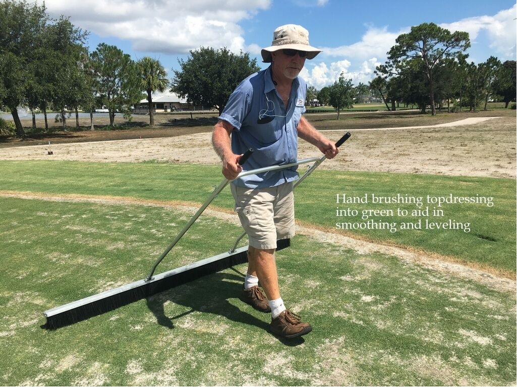 0137-Golf Rejuv – 20180715 – Hand Brushing top dressing into green to aid with smoothing and leveling