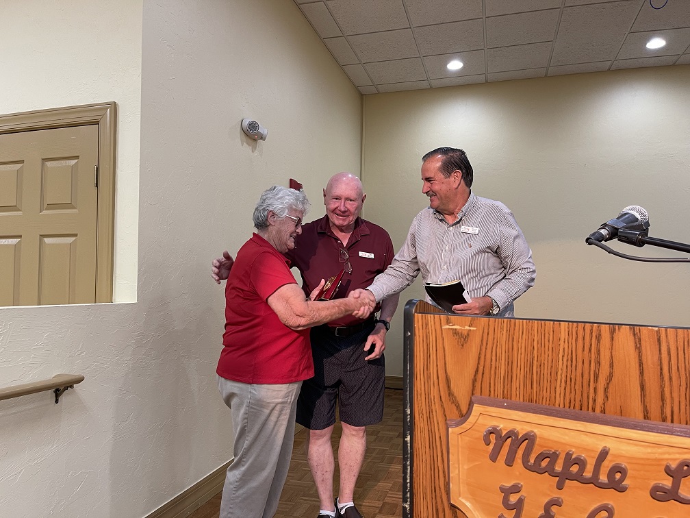 Mike Rooney and Mitch Krach present award to Linda Sanders for almost 40 years of service